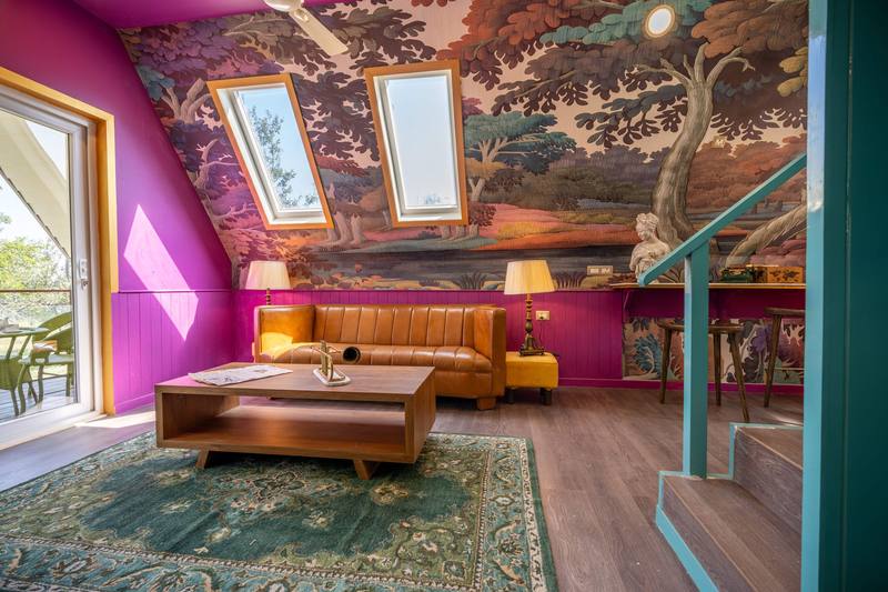 Living room lit by roof windows in the sloping ceiling